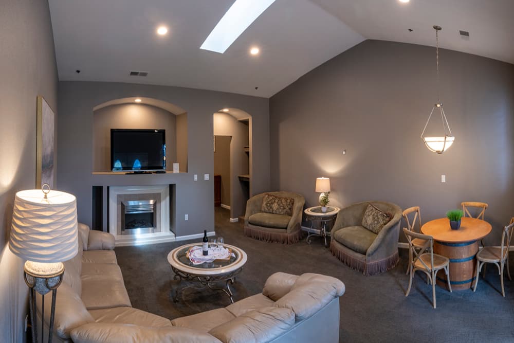 Cozy living room with a television, fireplace, and comfortable seating.